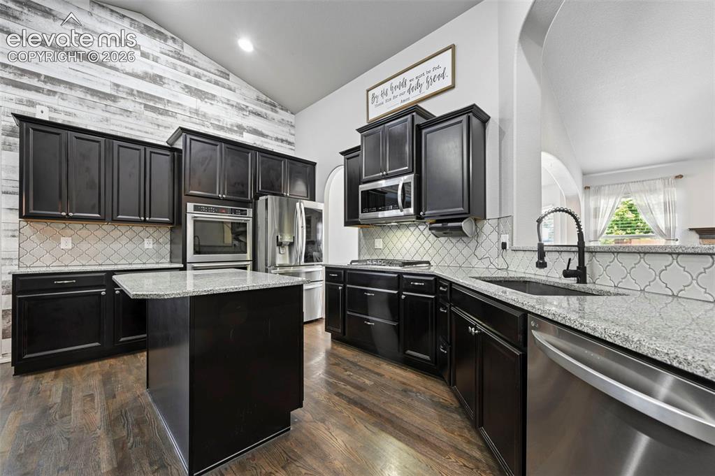 Image 12 of 50: Stunning designer gourmet kitchen w/ double ovens, coffee bar, stainless ap