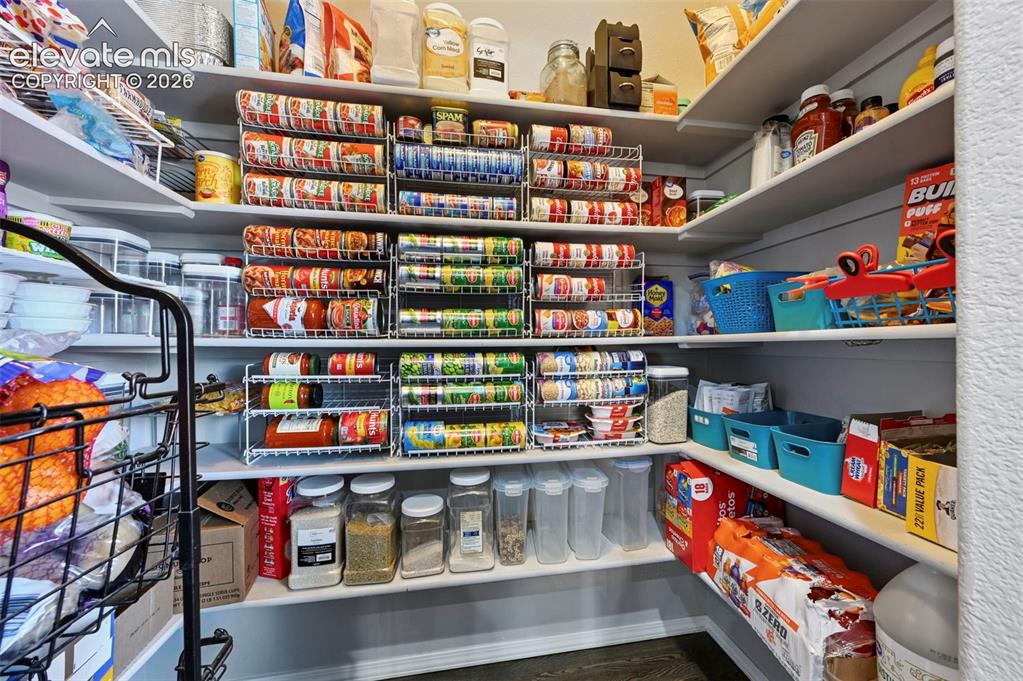 Image 15 of 50: Organization at its finest in this large walk-in pantry! 