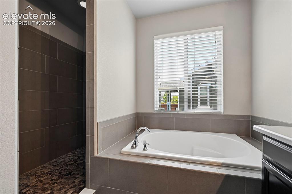 Image 20 of 50: Primary ensuite w/ walk in shower and large soaking tub! 