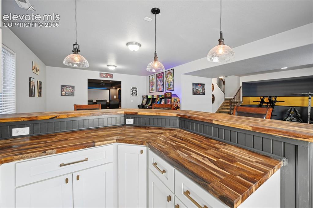 Image 30 of 50: Custom designer wetbar w/ real brick accent wall, custom cabinetry, mini-fr