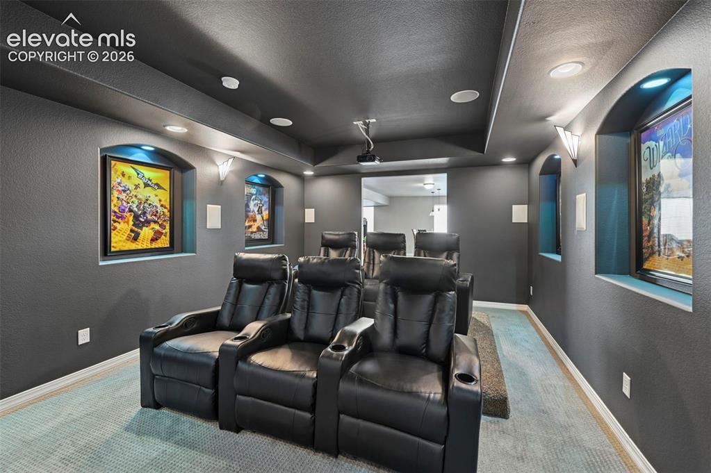 Image 33 of 50: True dedicated theater room w/ screen, elevated seating,  recessed alcoves,