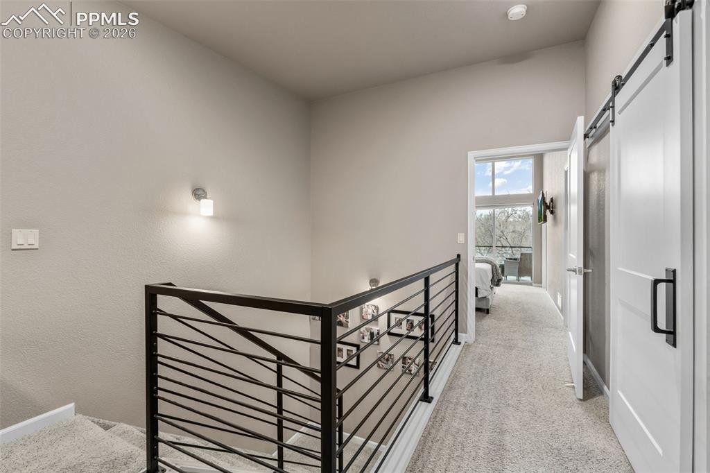 Image 11 of 28: Upstairs hallway with access to bedrooms and laundry