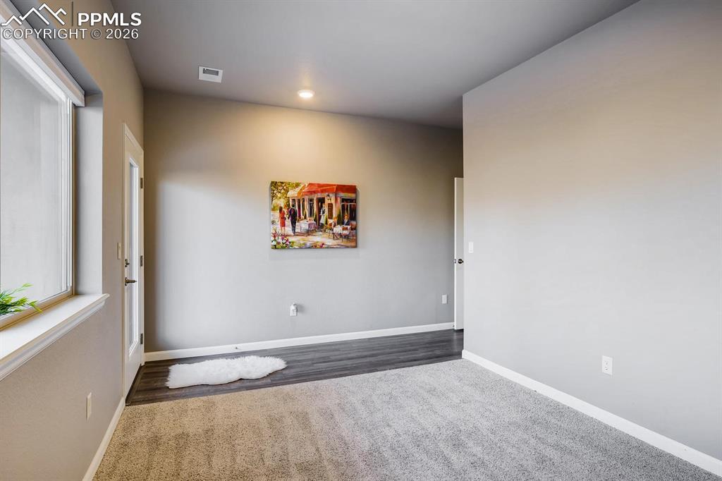 Image 23 of 29: Main floor bedroom with en-suite bath and private walkout to patio