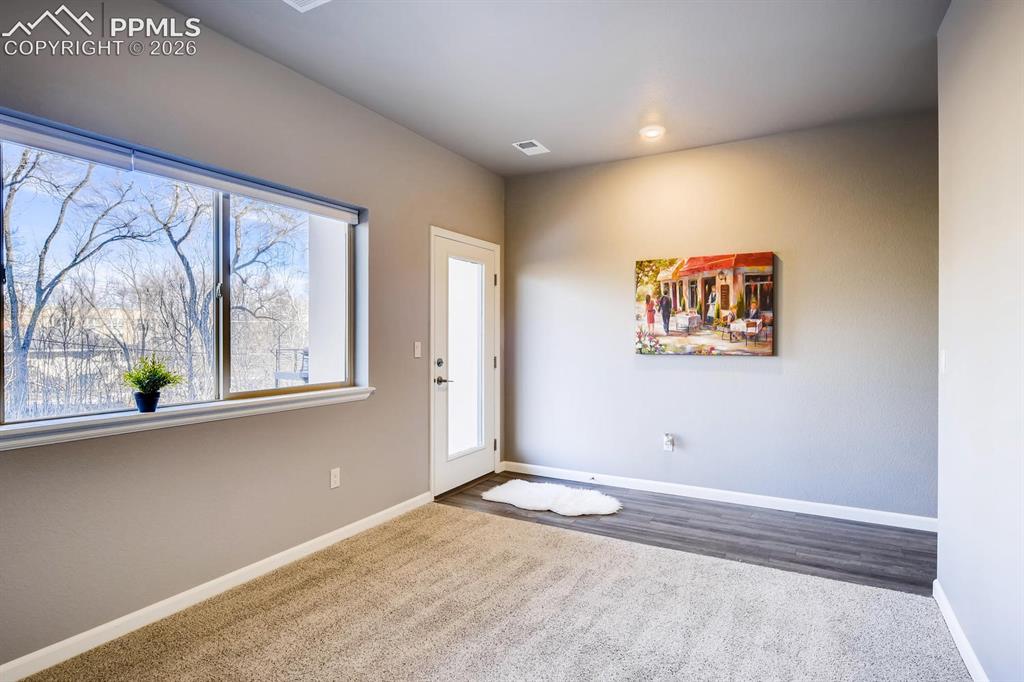 Image 23 of 28: First floor bedroom with en-suite bath and private walkout to patio