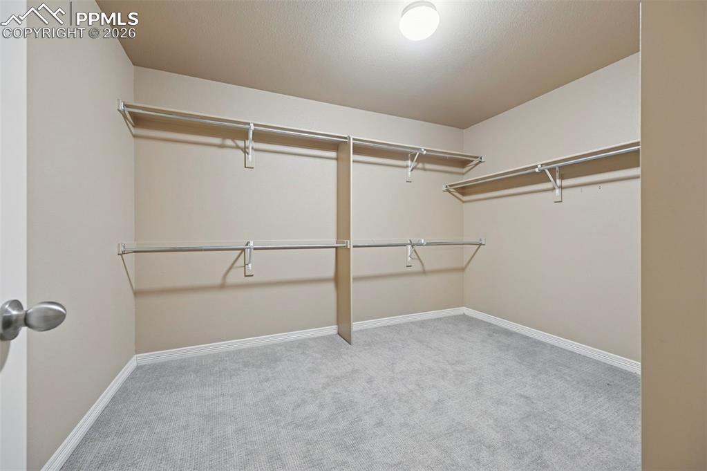 Image 24 of 38: Primary walk in closet