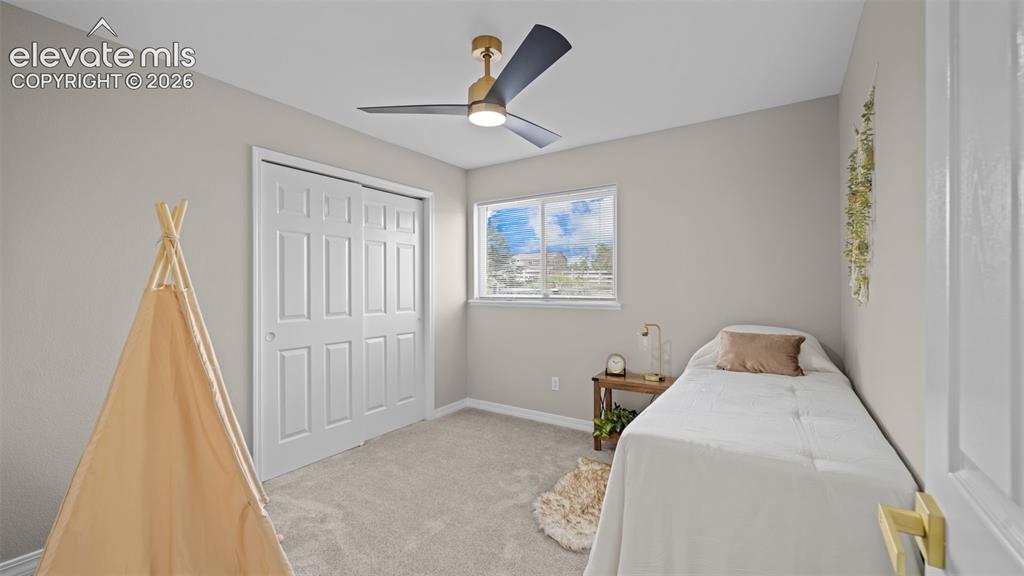 Image 21 of 48: Bedroom featuring neutral-toned walls, light carpet flooring, and a modern
