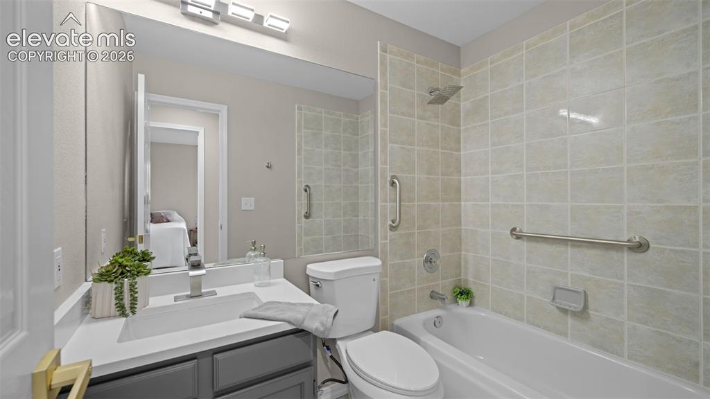 Image 22 of 48: Bathroom featuring a built-in tub with a tile surround, vanity with an inte