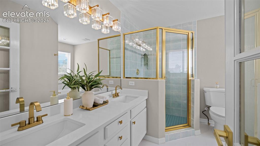 Image 25 of 48: Bathroom featuring a dual vanity with white cabinetry and integrated sinks,