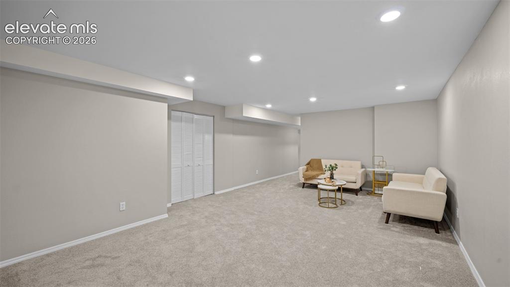 Image 29 of 48: Spacious room featuring neutral carpeting, recessed lighting, and light-ton