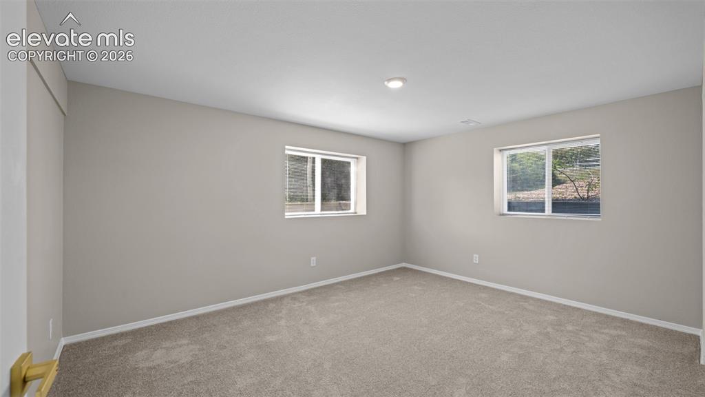 Image 35 of 48: Carpeted bedroom in basement