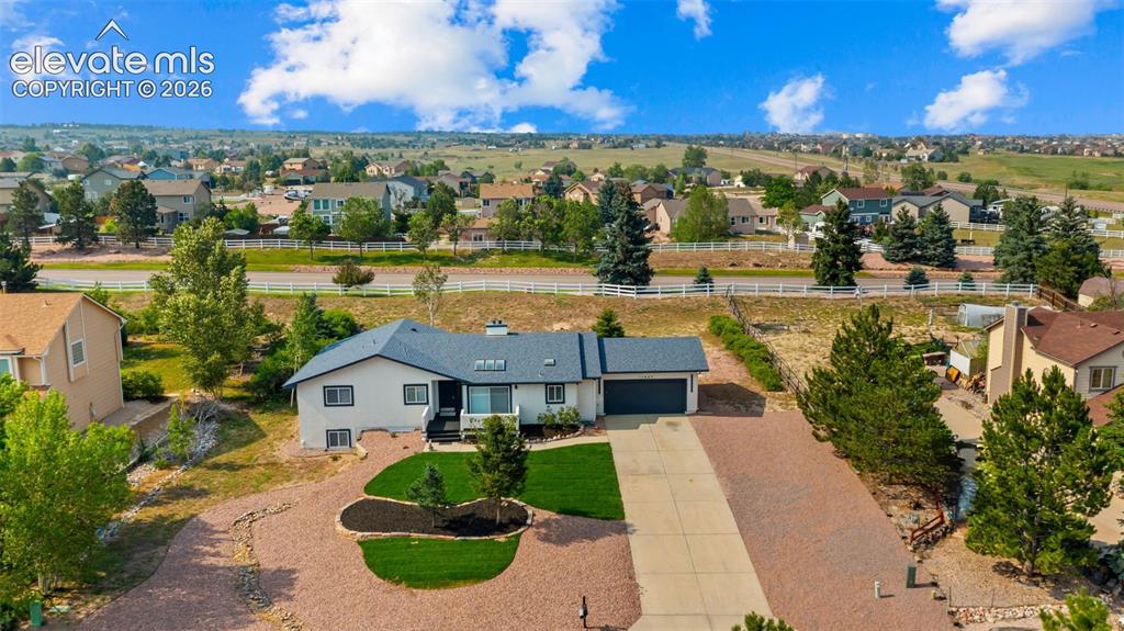 Image 39 of 48: Ranch-style residence featuring a light-colored exterior with dark trim and
