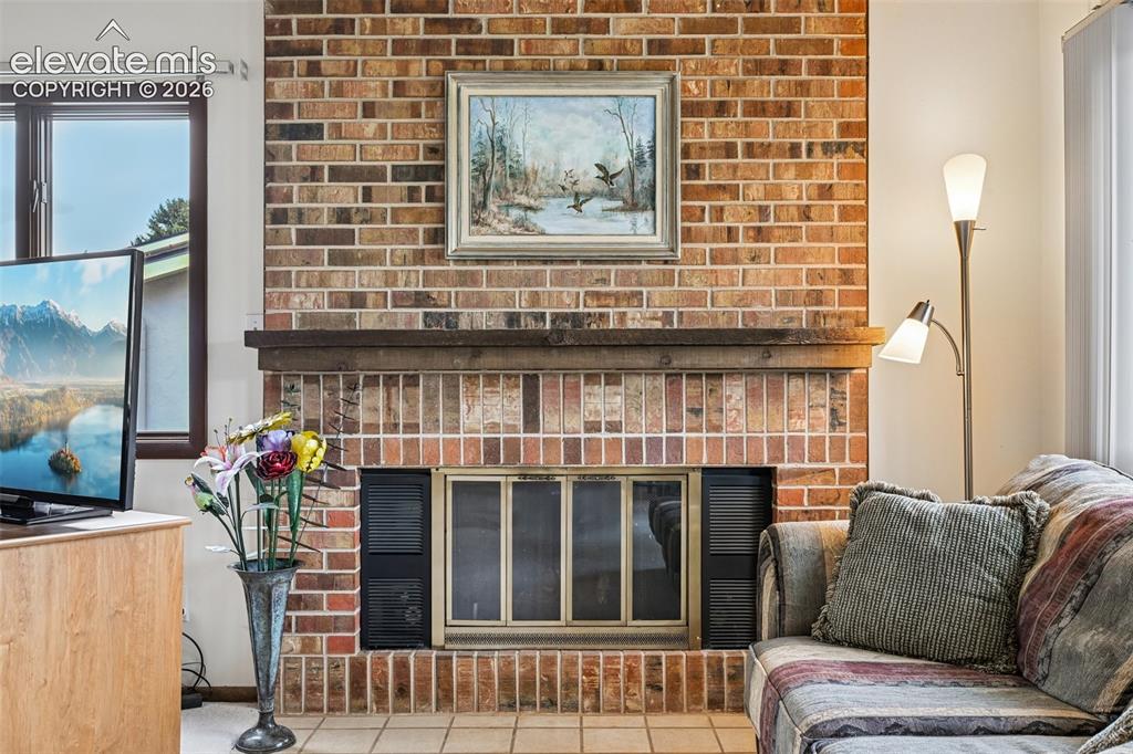 Image 6 of 30: Cozy brick fireplace