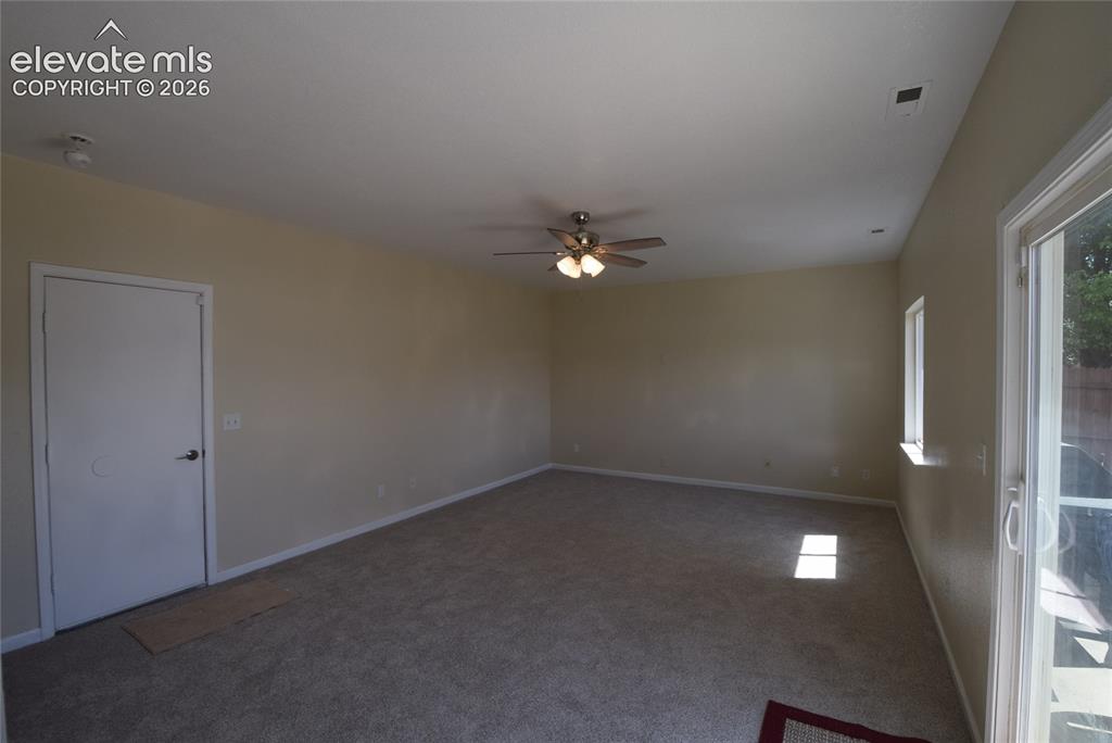 Image 13 of 45: Spacious room featuring neutral carpeting and light-colored walls