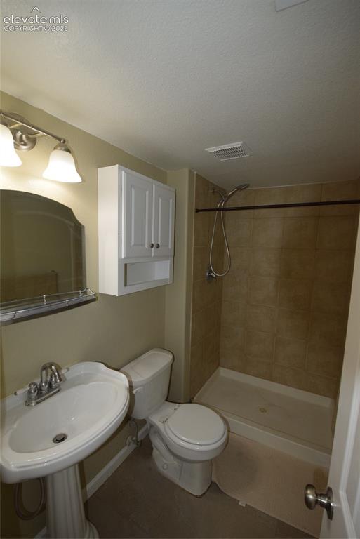 Image 15 of 45: Pedestal sink with chrome fixtures, coordinating wall-mounted light fixture