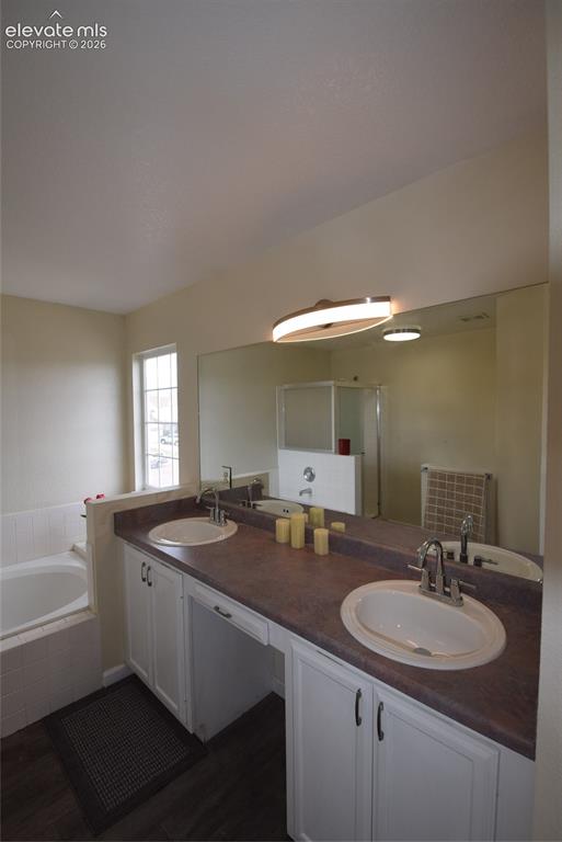 Image 30 of 45: Dual vanity with white cabinetry and integrated sinks