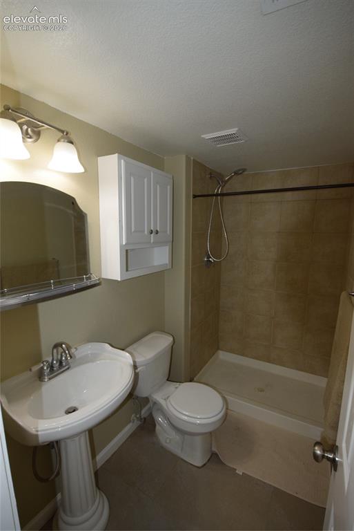 Image 35 of 45: Pedestal sink with chrome faucet, complemented by a mirrored vanity light f