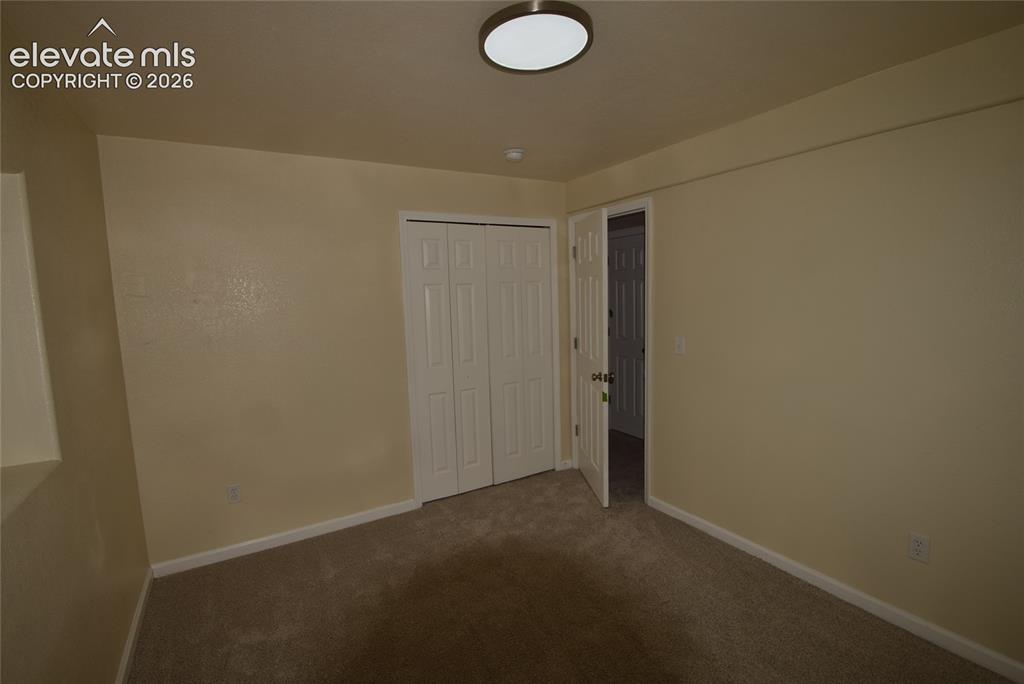 Image 36 of 45: Neutral-toned wall finishes with a light-colored carpeted floor