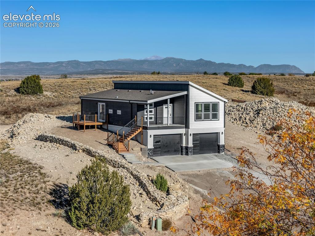 Image 1 of 50: Modern exterior with dark siding, a split-entry layout, and multiple decks—