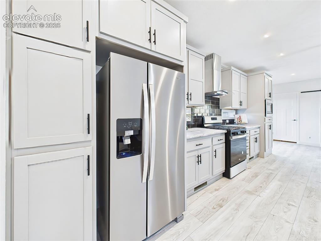 Image 15 of 50: Abundant cabinet storage, built-in microwave, and refrigerator with ice/wat