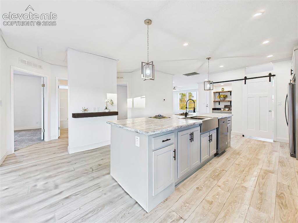 Image 18 of 50: View from the island showcasing open flow into the Bedroom hall and abundan
