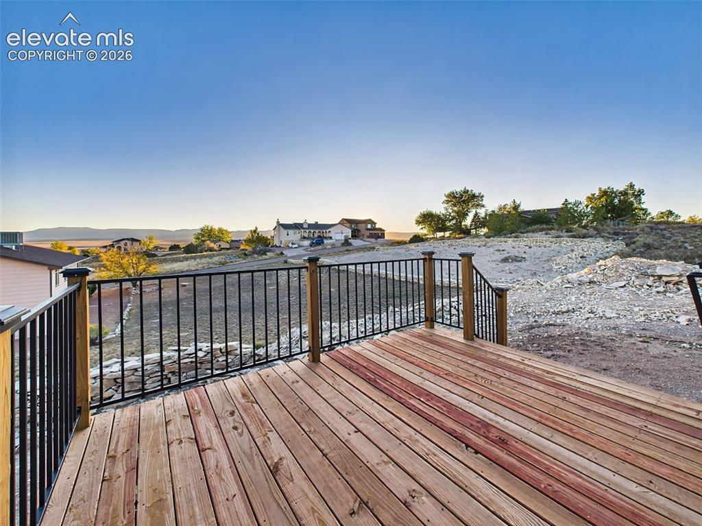 Image 24 of 50: Wood deck with mountain backdrop—perfect for entertaining or relaxing outdo