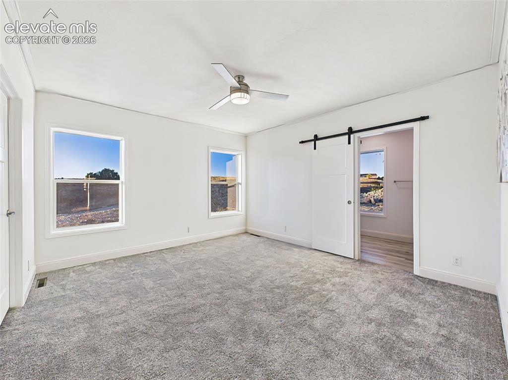Image 27 of 50: Un staged version showing clean lines, neutral tones, and dual windows for 