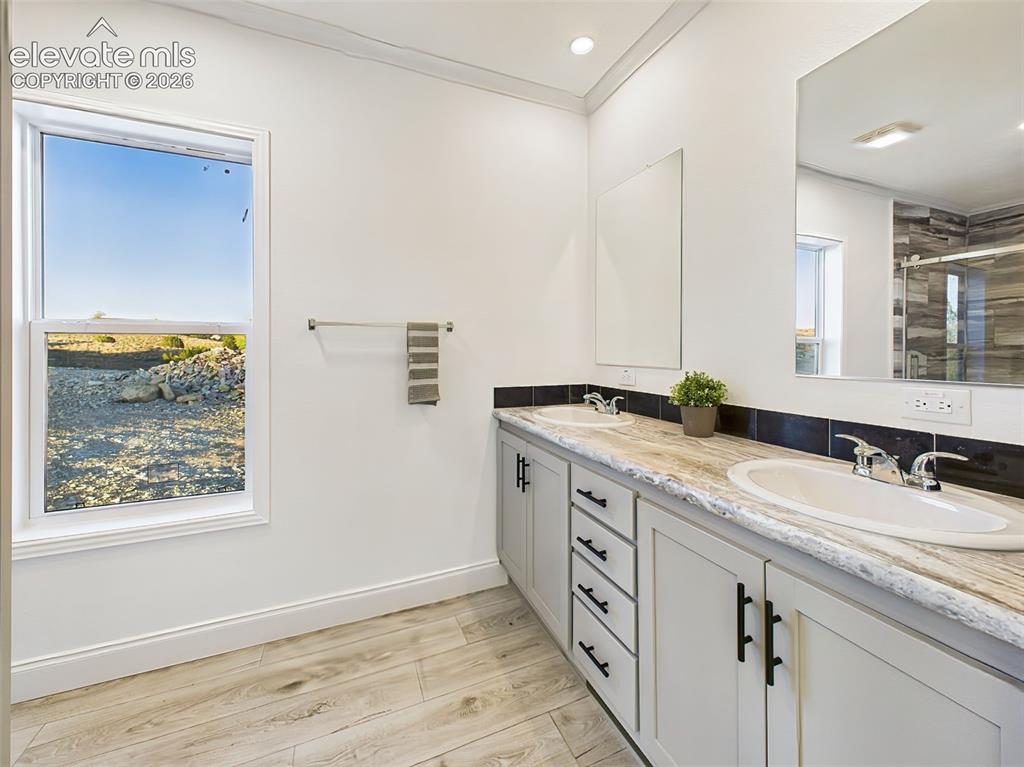 Image 31 of 50: Beautifully appointed ensuite with dual sinks, and ample cabinetry.