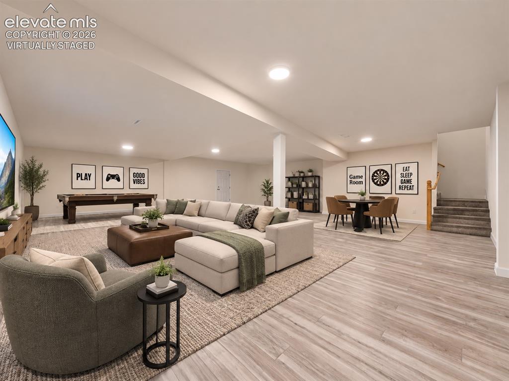 Image 45 of 50: Virtually Staged Basement – Virtually staged as an inviting entertainment r