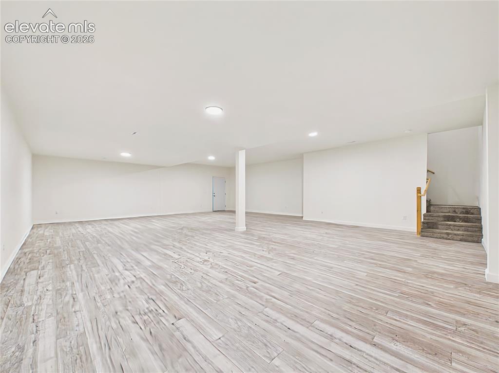 Image 46 of 50: Finished Basement – Wide-angle view emphasizes the scale of the finished lo