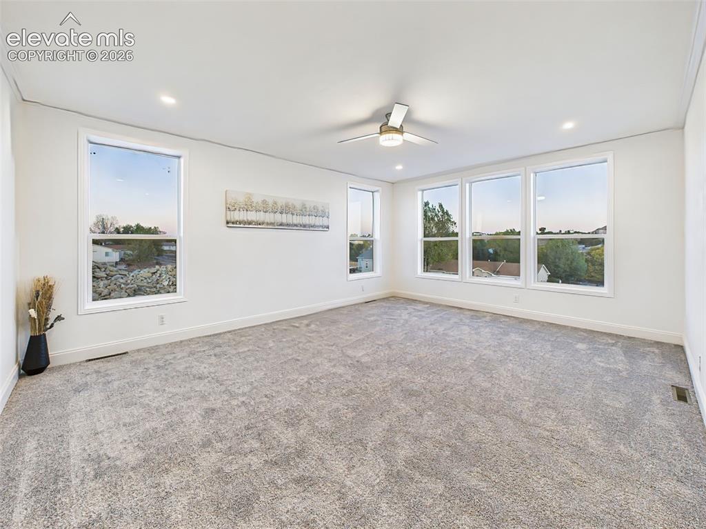 Image 7 of 50: Un-staged version of the main living area, highlighting the fresh paint, ne