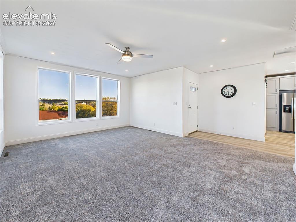 Image 9 of 50: Unstaged version of the main living area, highlighting the fresh paint, new