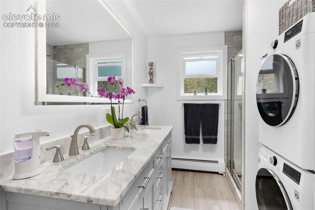 Image 11 of 28: Upper level bathroom and laundry room