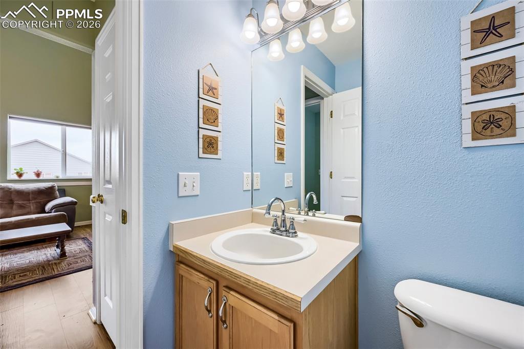 Image 16 of 32: Bathroom vanity featuring a built-in sink and chrome faucet
