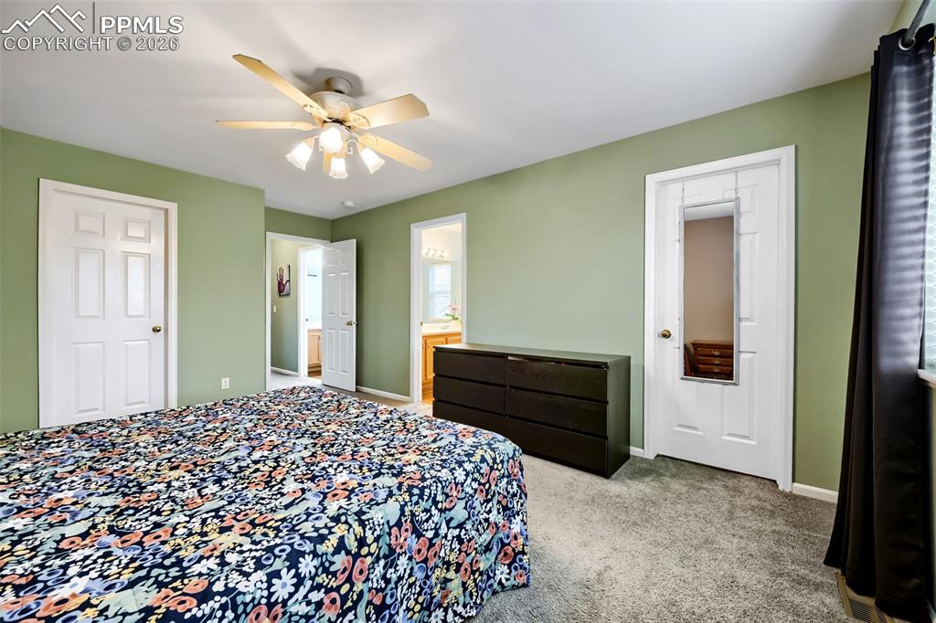 Image 20 of 32: Carpeted interior room featuring light green walls and white trim