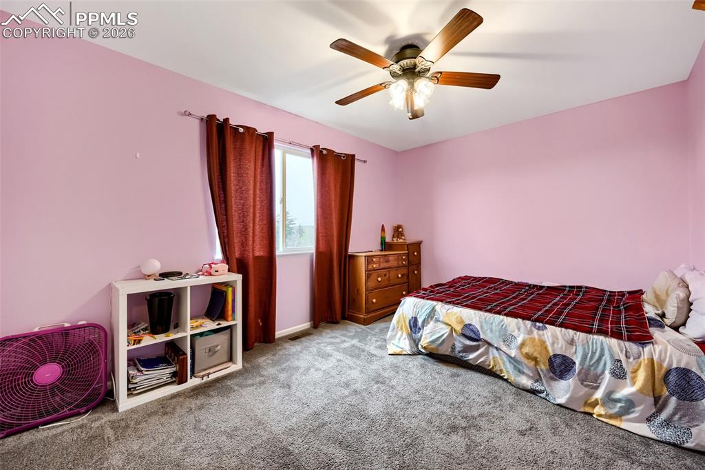 Image 26 of 32: Bedroom featuring a ceiling fan with integrated lighting, a single window, 