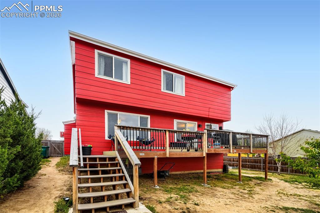 Image 31 of 32: Red siding exterior featuring white trim and multiple windows
