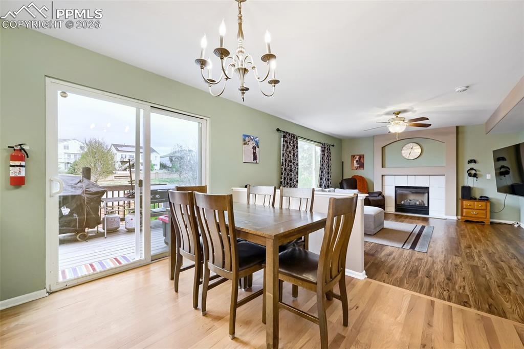Image 7 of 32: Open-concept living space featuring wood-finish flooring, a fireplace with 
