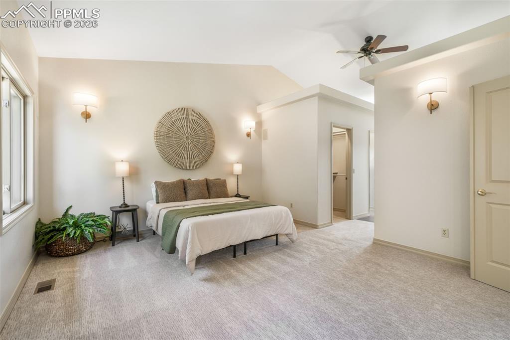Image 11 of 50: Vaulted living area featuring a floor-to-ceiling stacked stone fireplace wi
