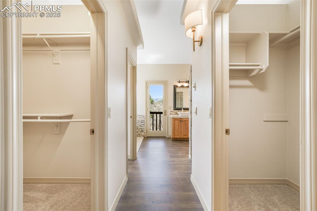Image 14 of 50: Entry foyer featuring dark wood-finish flooring, a dark paneled entry door,