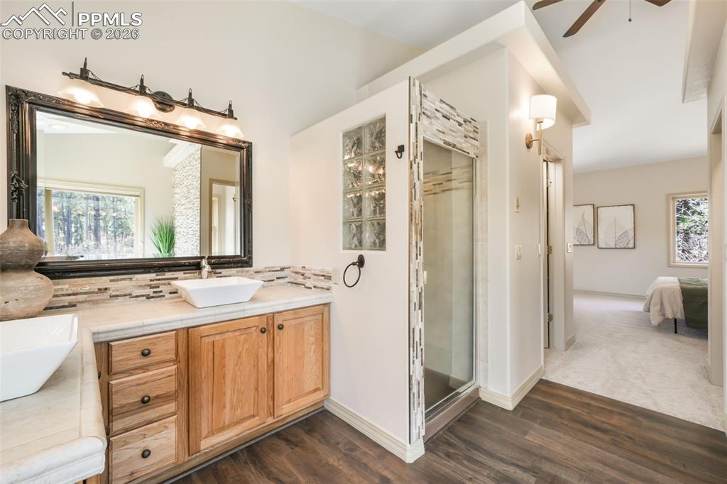 Image 17 of 50: Vaulted ceiling bedroom featuring plush carpeting, two large windows, an op