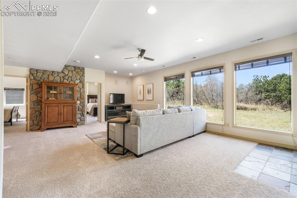 Image 32 of 50: Kitchen island with a light-toned countertop, wood-finish flooring, oak cab