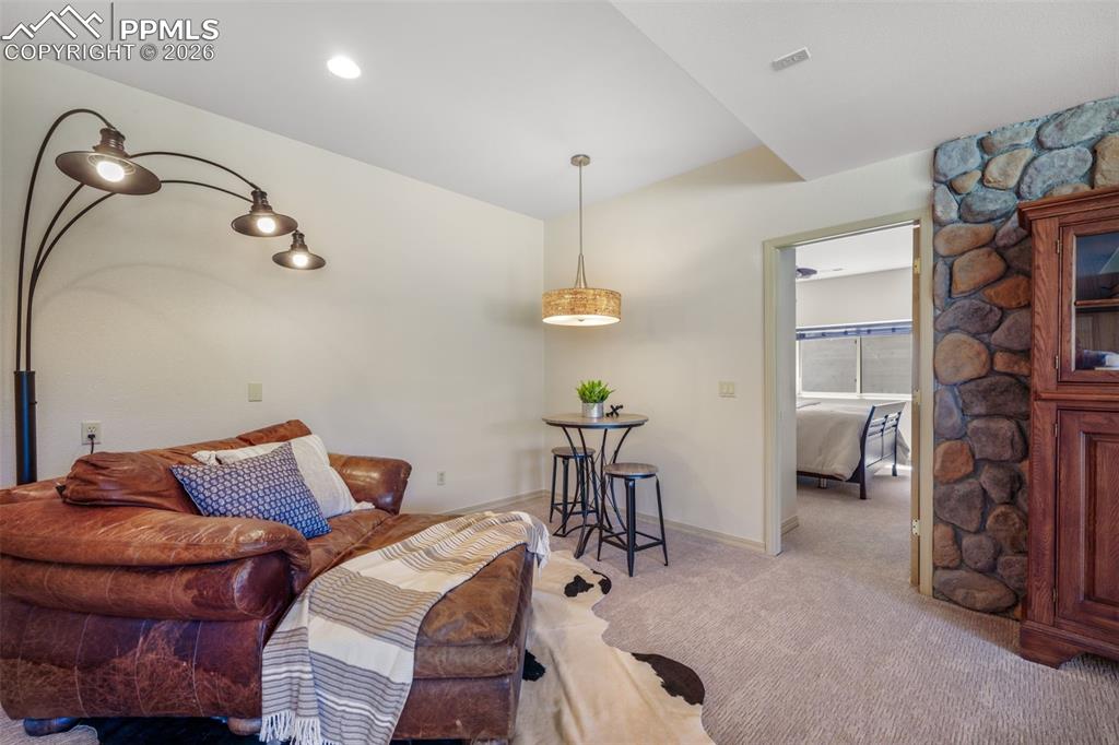 Image 34 of 50: Bathroom featuring a framed vanity mirror, dual wall sconces, wood-finish c