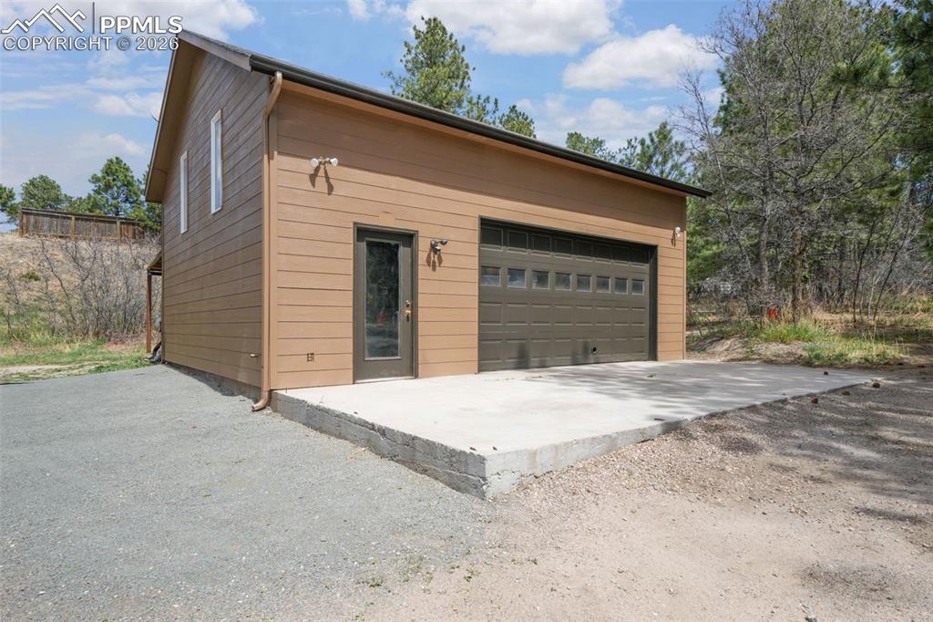 Image 4 of 50: Ranch-style residence featuring a stone and stucco exterior, an attached tw