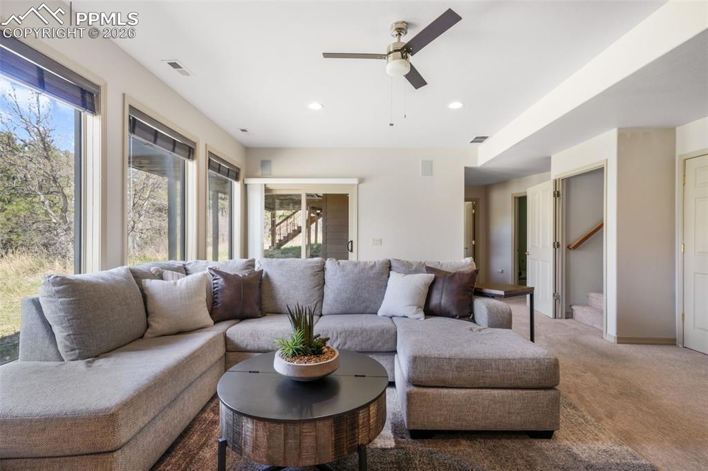 Image 40 of 50: Shower enclosure with tiled walls, gold-finish framing, and a glass sliding