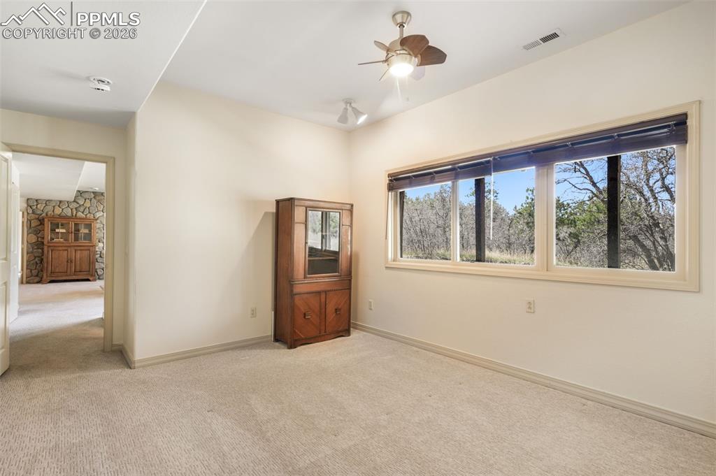 Image 43 of 50: Spacious living area featuring large windows, recessed lighting, and a ceil