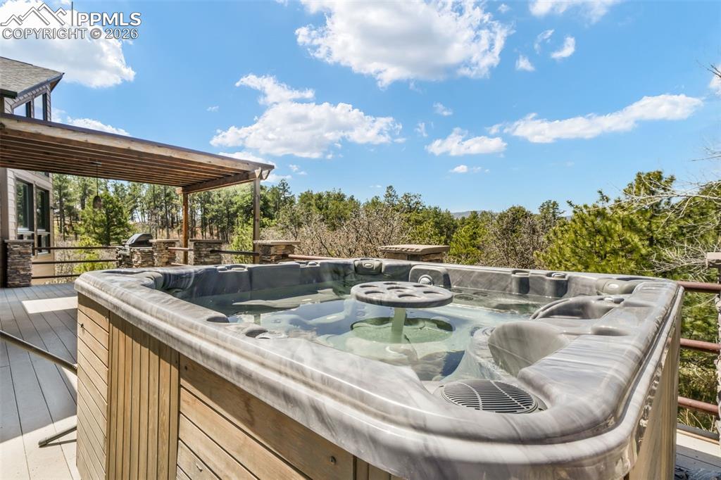 Image 47 of 50: Carpeted room featuring a wide window with exterior tree scenery, a ceiling