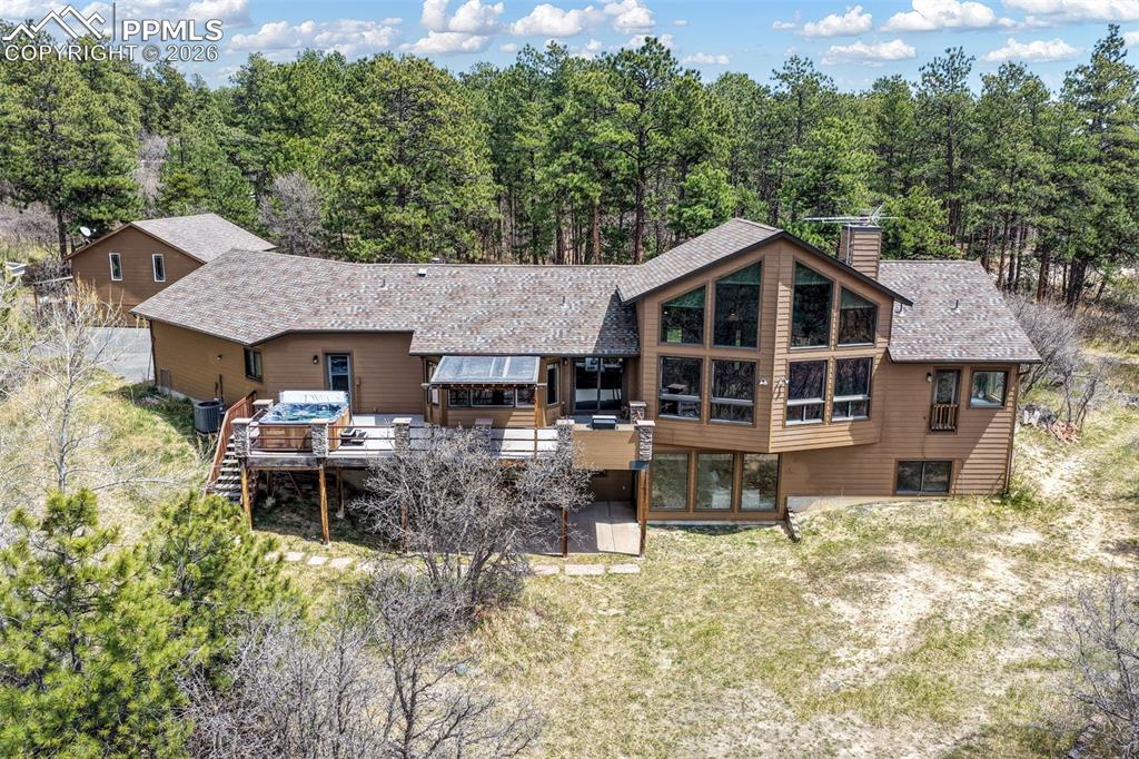 Image 49 of 50: Expansive outdoor deck featuring wood-finish flooring, a built-in hot tub, 
