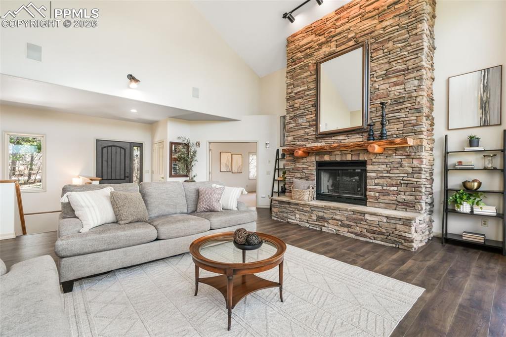 Image 8 of 50: Detached two-story structure featuring tan siding, a dark brown garage door