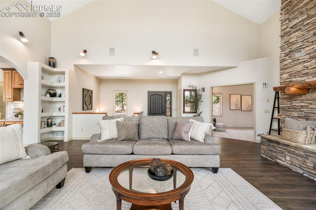 Image 9 of 50: Vaulted ceiling great room with abundant natural light from a wall of windo