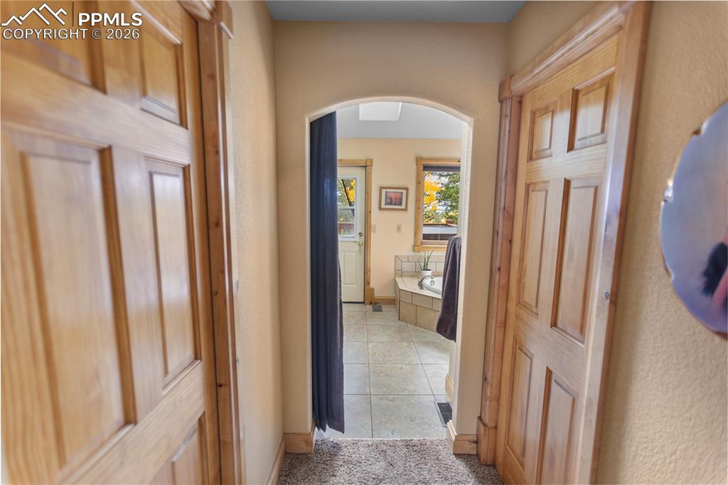 Image 16 of 40: Main level master suite.